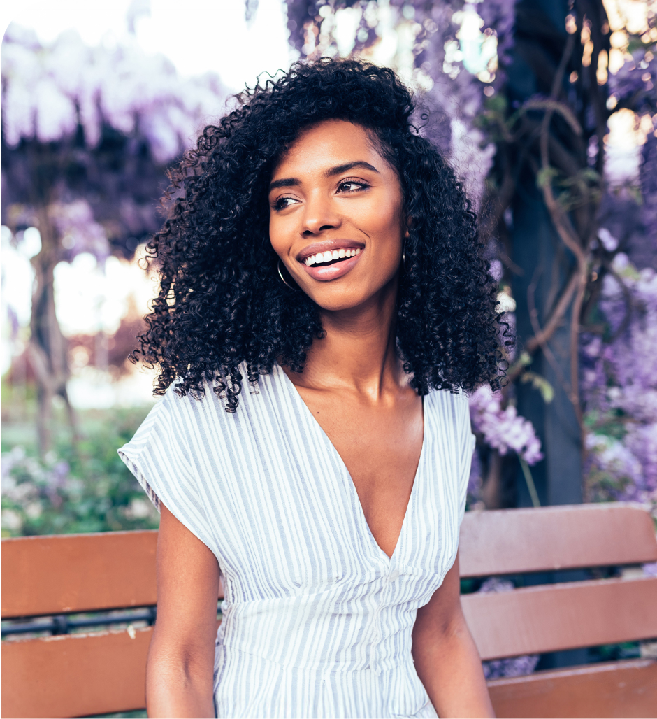 young woman smiling on a park bench