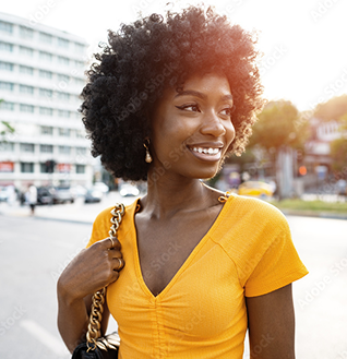 Woman smiling in front of building